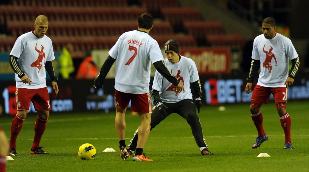 Liverpool players wear T-shirts supporting Luis Suarez, who was banned for racially abusing Manchester United's Patrice Evra