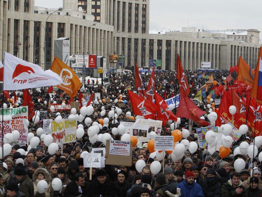 Demonstrators hold placards, flags and balloons during today's protest against recent parliamentary election results in Moscow