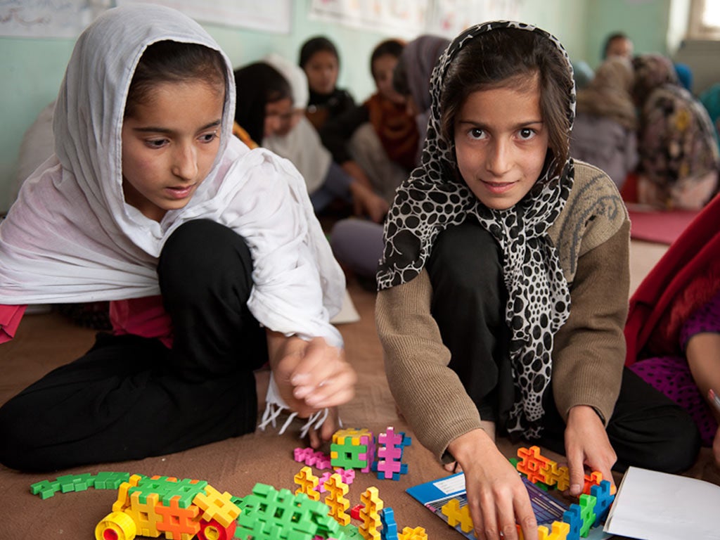 Young Afghan girls take a break from carrying out household
chores to attend a Save the Children outreach centre in Kabul