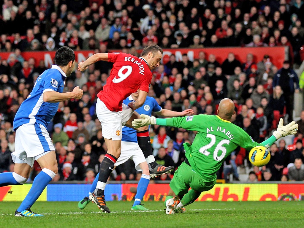 Dimitar Berbatov scores his second goal against Wigan Athletic