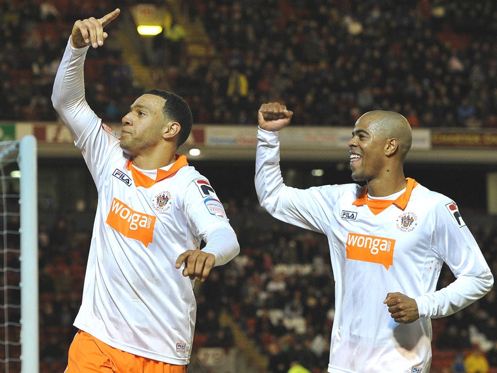 Blackpool’s Matt Phillips (left), who hit a hat-trick, and Ludovic Sylvestre celebrate the 3-1 win over Barnsley