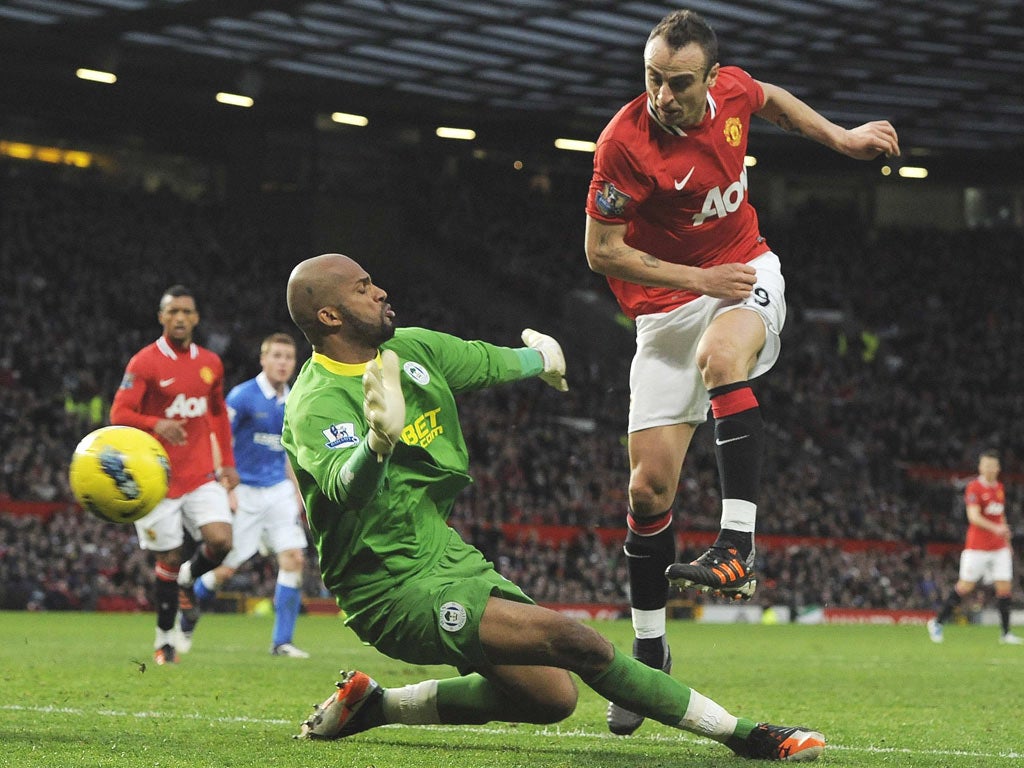 Manchester United’s hat-trick hero Dimitar Berbatov scores against Wigan