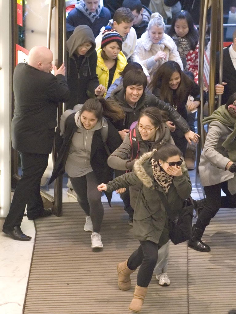 Sales rush: shoppers sprint into Selfridges on the first day
of the sales at the department store’s Oxford Street branch.
Analysts reported a flood of retail tourists from China