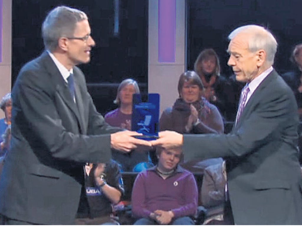 Simon Calder accepts the winning trophy from John Humphrys