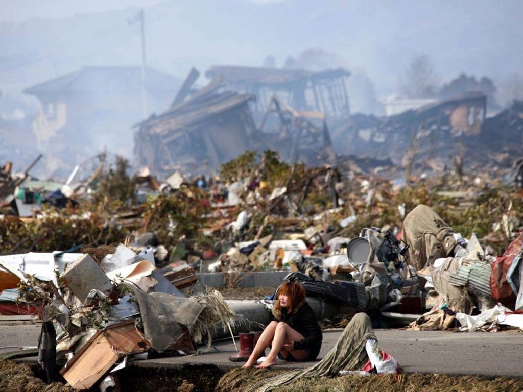 <p><strong>After the Tsunami, Japan<br/></strong><em>13 March</em></p>
<p>A woman sits and weeps amid the remains of the city of Natori in northern Japan, after a massive earthquake and tsunami that killed around 15,000 people, as well as causing catastrophic damage to the Fukushima nuclear power plant</p>