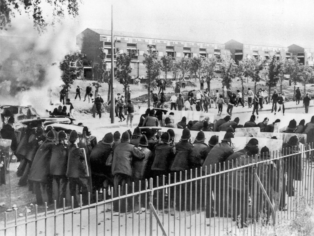 Lines of police with riot shields face a group of youths during riots in the Toxteth area of Liverpool, July 1981