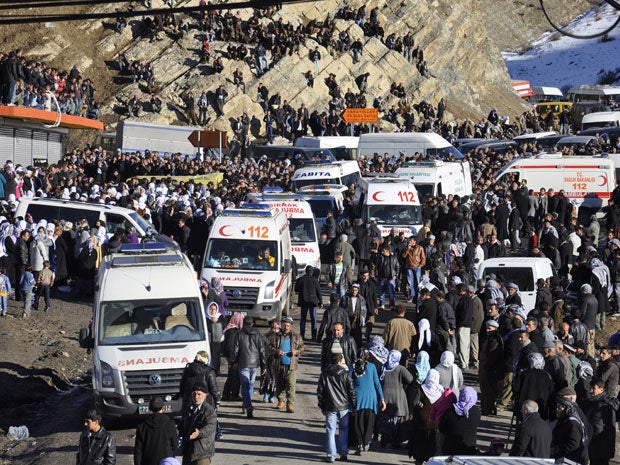 People gather near a hospital morgue yesterday after bodies of victims killed in the air strikes arrived in the Turkish town of Uludere