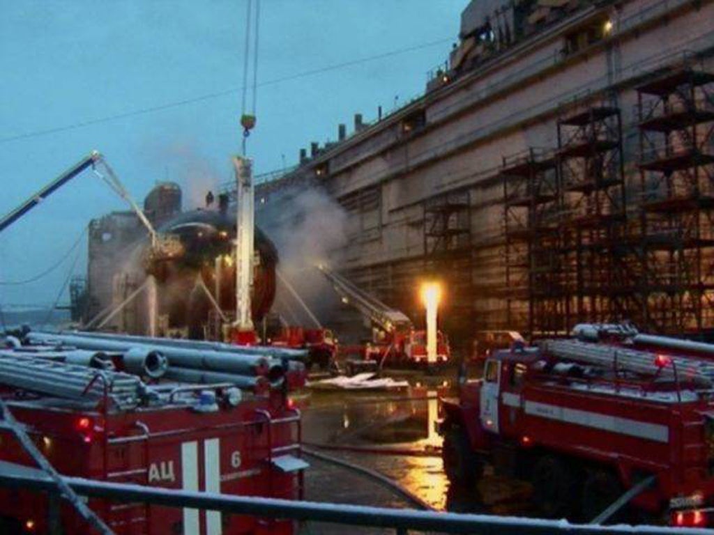 Firefighters spray water on the Yekaterinburg nuclear submarine