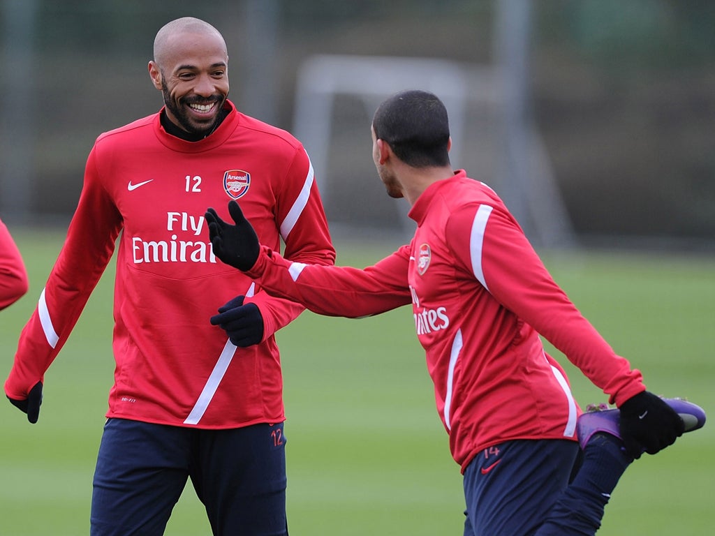 Thierry Henry (left) trains with Theo Walcott at London Colney yesterday