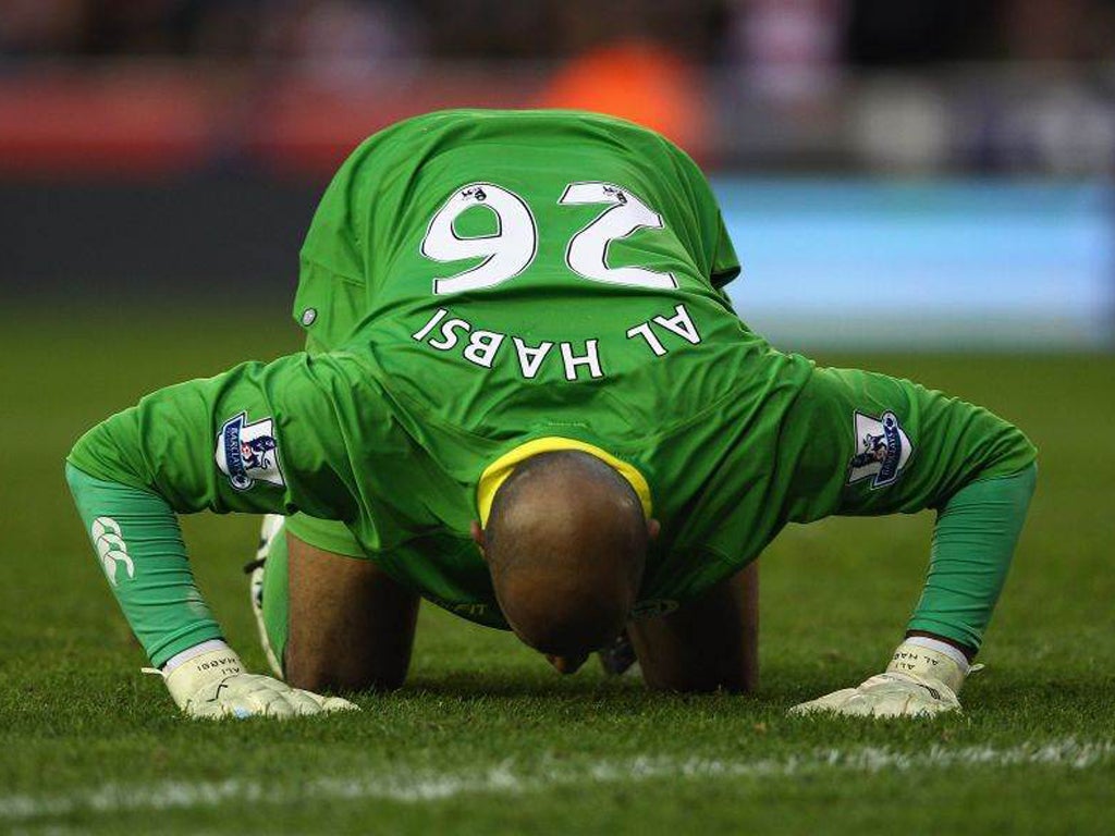 Wigan Athletic goalkeeper Ali Al-Habsi kisses the turf as his team earn an unlikely point at Stoke