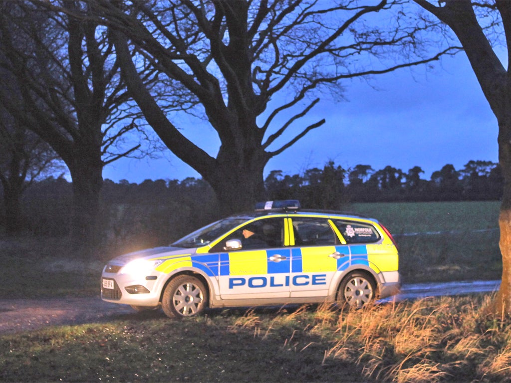 Police guarding the entrance to the woods on the Sandringham Estate where the remains were found