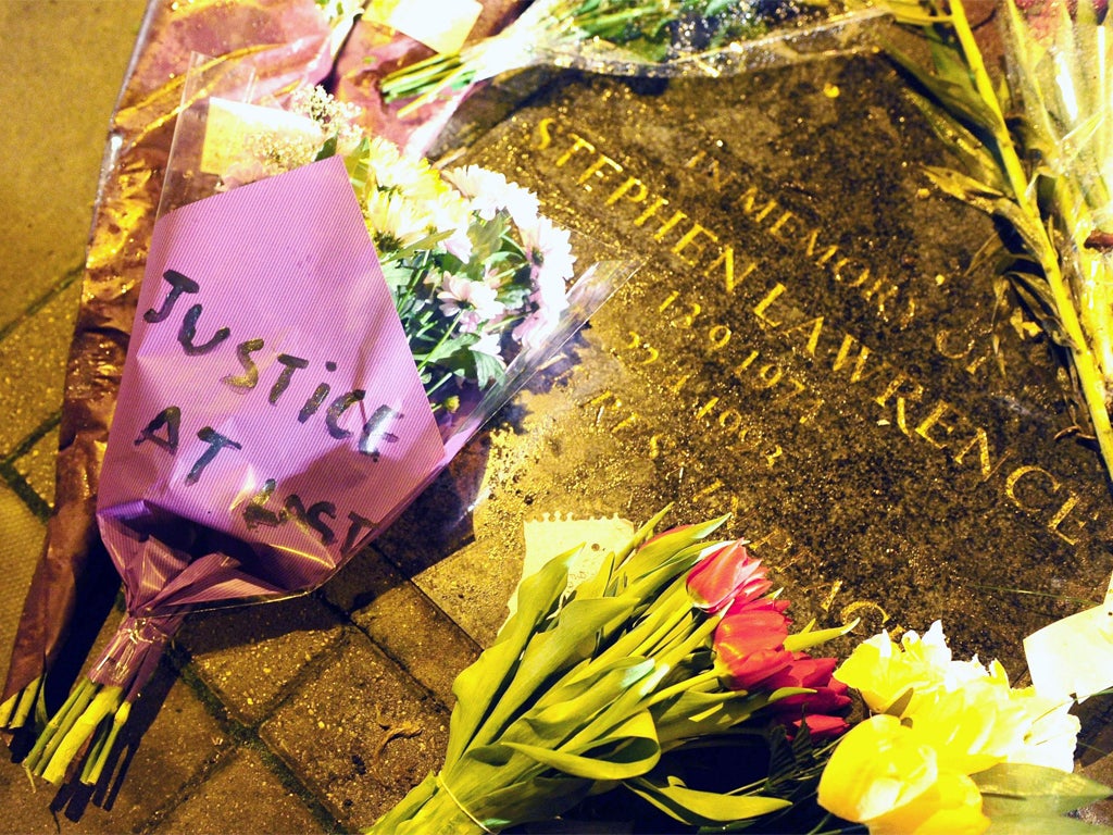 Flowers are left on the memorial plaque to Stephen Lawrence at the bus stop in Eltham, south-east London, where he died