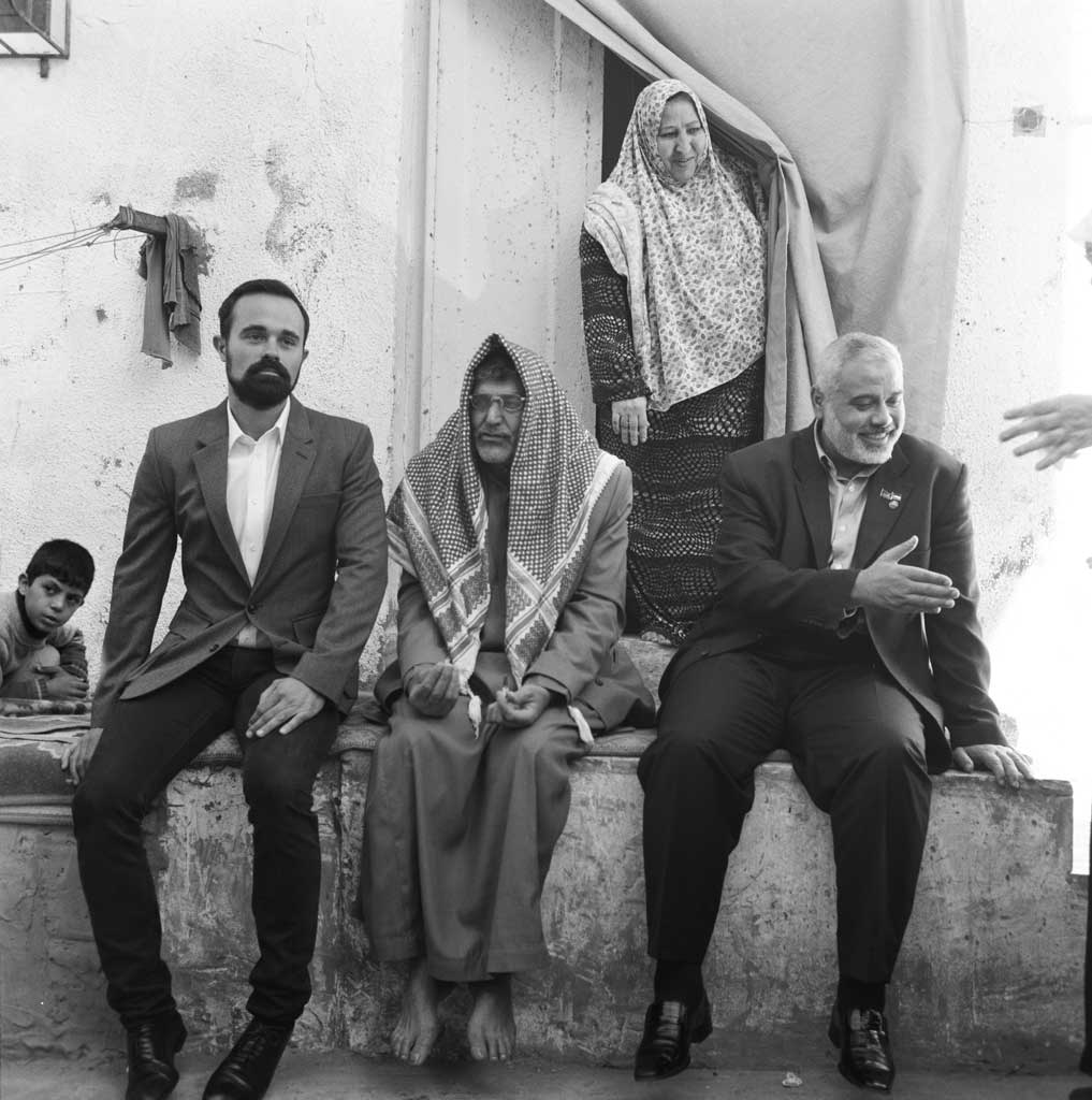Evgeny Lebedev (left) with Saed Ibrahim Abdullah, a 55-year-old unemployed fisherman, and his wife, and (right) Ismail Haniyeh