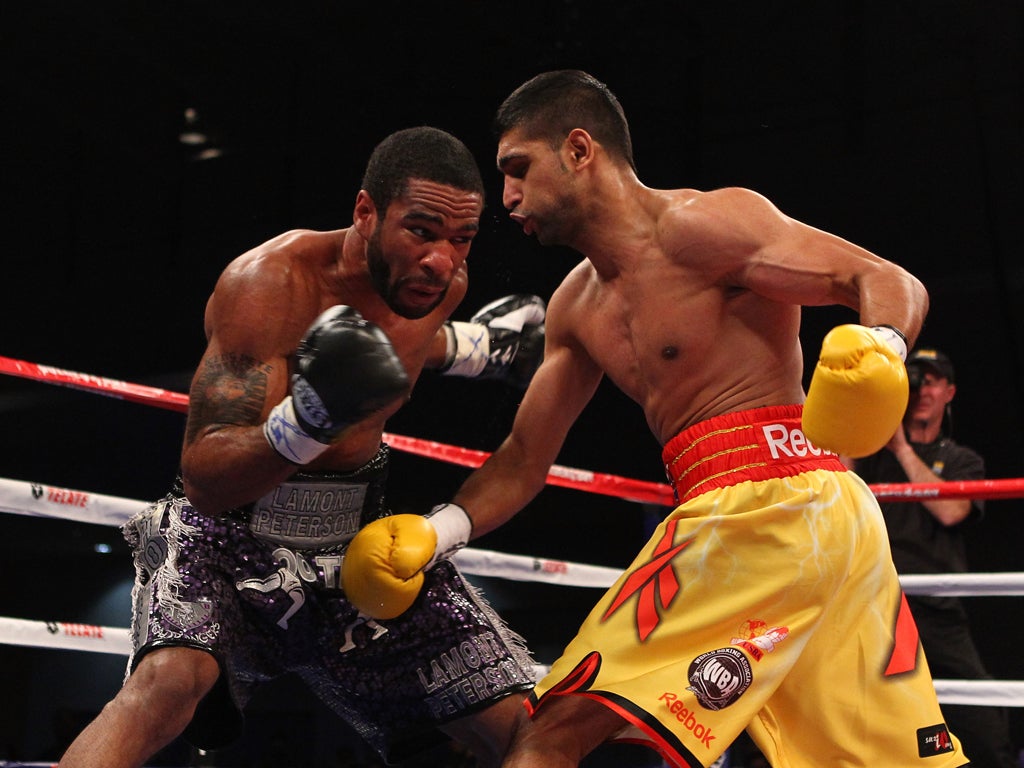 During Amir Khan's (right) world title defence there was a man in a hat who allegedly 'interfered' with supervisor Michael Walsh