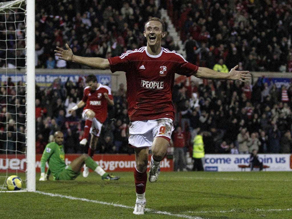 Swindon's Paul Benson celebrates his goal which knocked Wigan Athletic out of the FA Cup at the County Ground yesterday