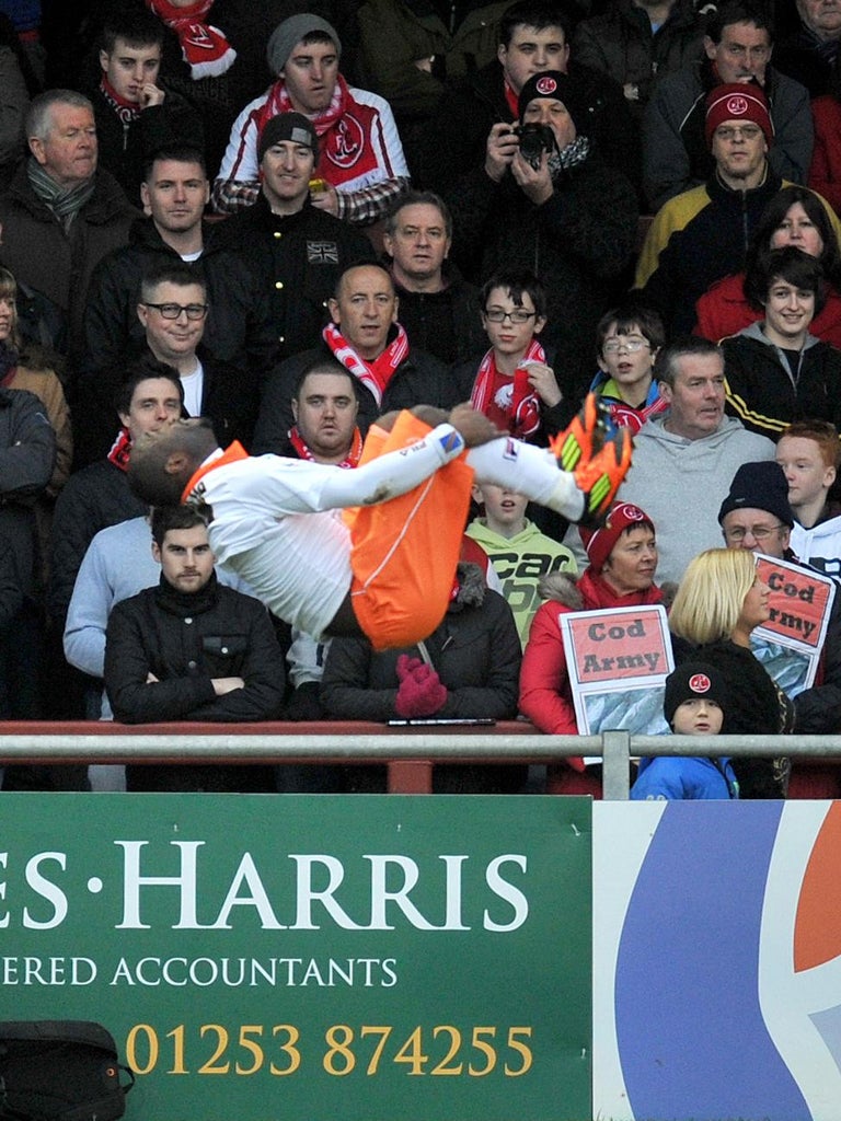 Members of the Cod Army are silenced as Lomana Lua Lua celebrates with his trademark somersault after scoring Blackpool's opener