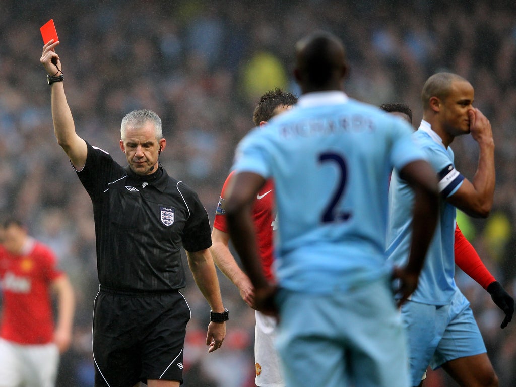 Referee Chris Foy sends off Vincent Kompany (right)