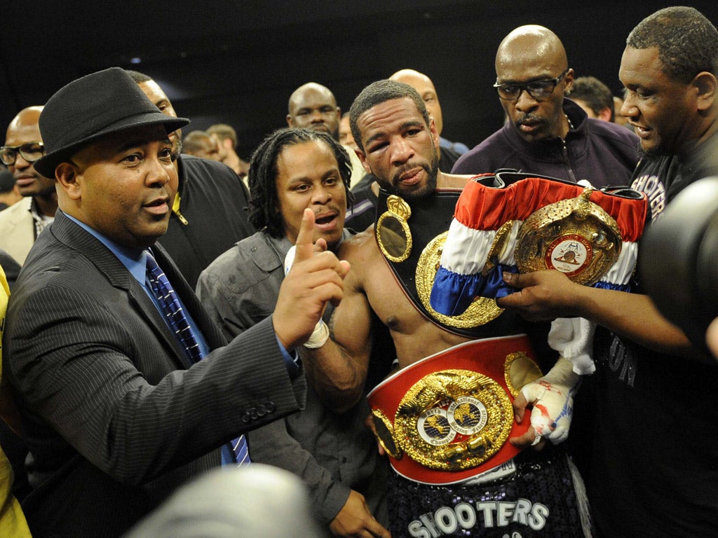 Mustafa Ameen (left) sat with officials during Amir Khan’s title fight, then climbed into the ring with winner Lamont Peterson