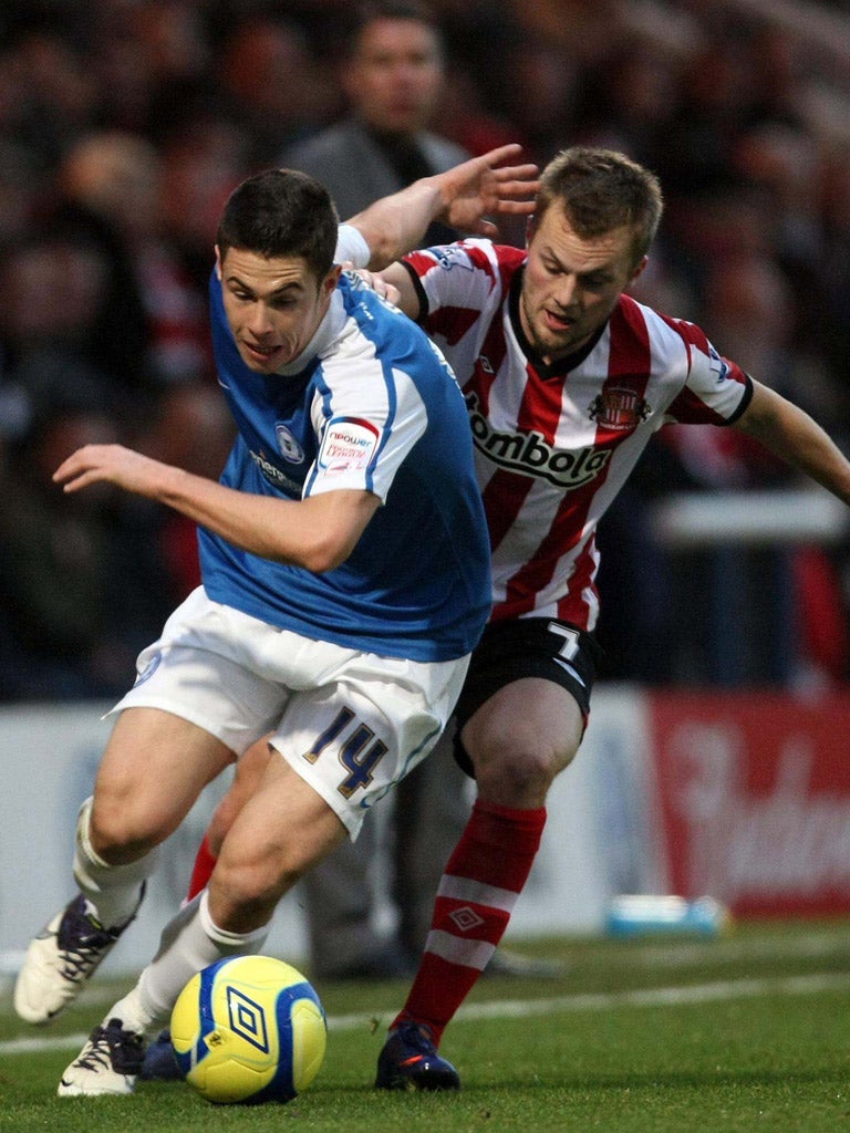 Sunderland’s Sebastian Larsson pursues Peterborough’s Tommy Rowe yesterday