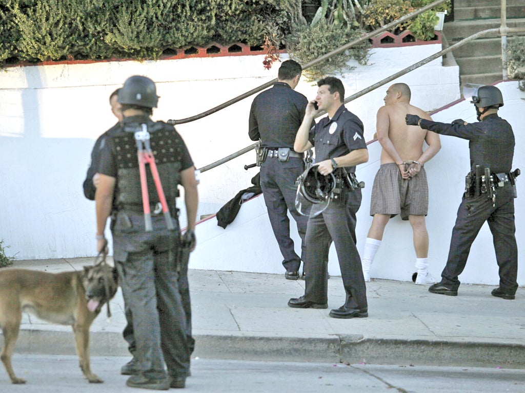 Los Angeles police officers arrest a man after a shooting