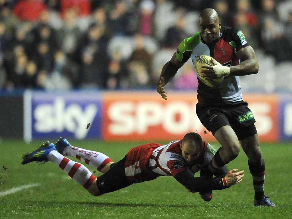 Ugo Monye of Harlequins is tackled by Gloucester's Charlie Sharples at the Stoop