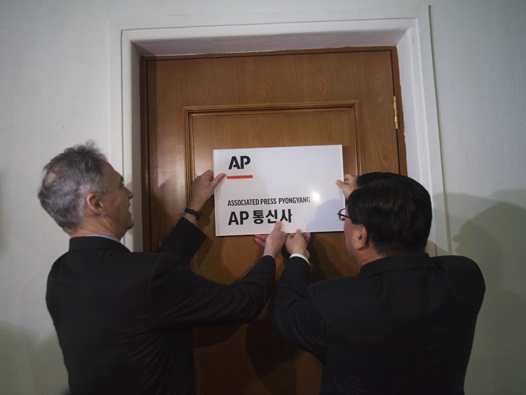 AP President Tom Curley, left, opens the new Pyongyang bureau