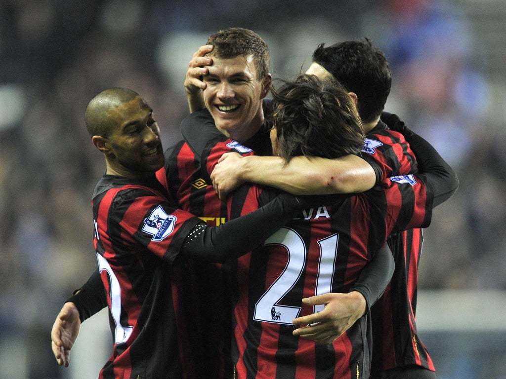 Edin Dzeko is congratulated by team-mates after scoring last night