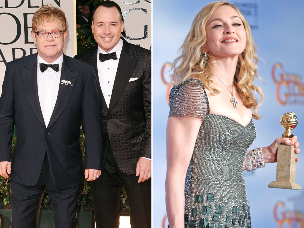 David Furnish, left with Sir Elton John at the Golden Globes, criticised the decision to give Madonna the best original song award