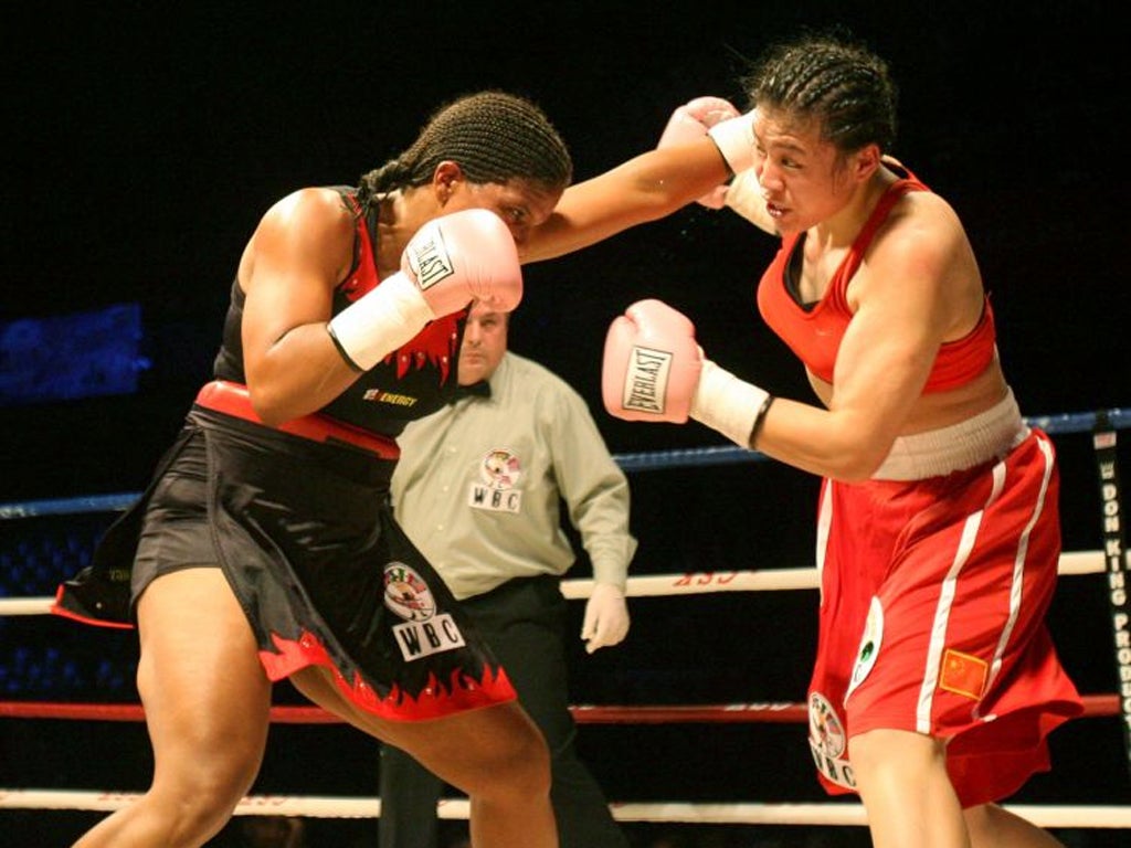 Boxing authorities will have to decide whether women boxers should wear skirts, as in the South African bout above, or shorts at the Olympics