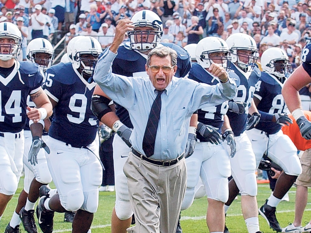 Inspirational: Paterno with his Penn State side in 2004; he also tried to ensure that all his charges graduated