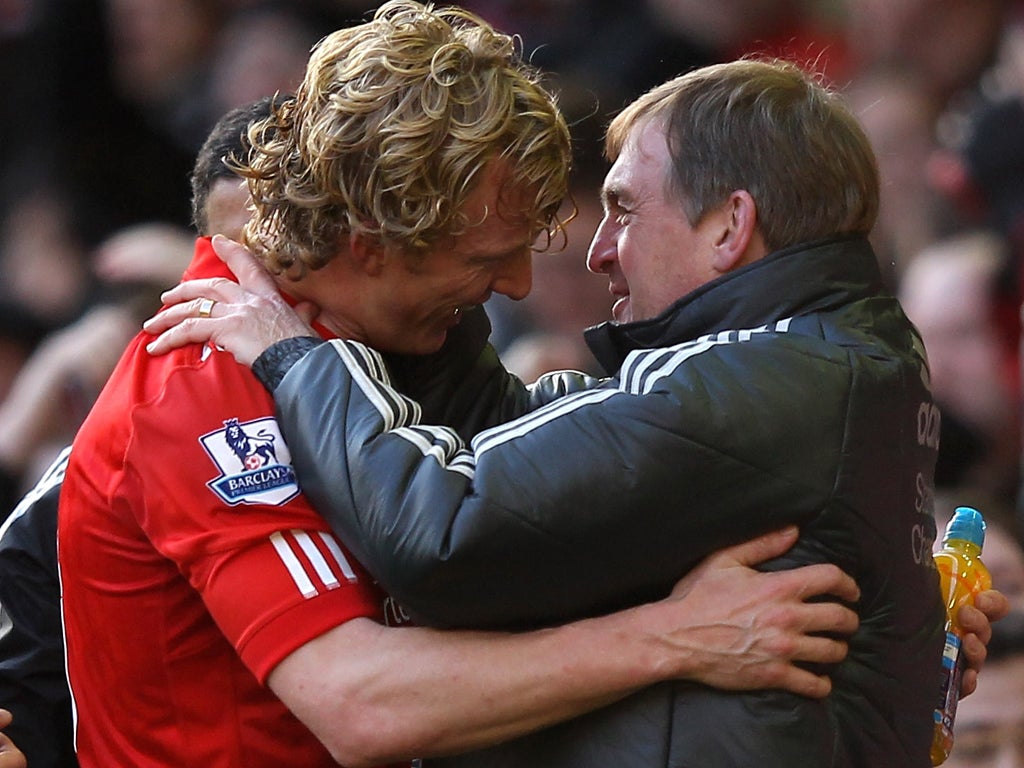 Liverpool Manager Kenny Dalglish embraces Dirk Kuyt at the end of the FA Cup Fourth Round match between Liverpool and Manchester United