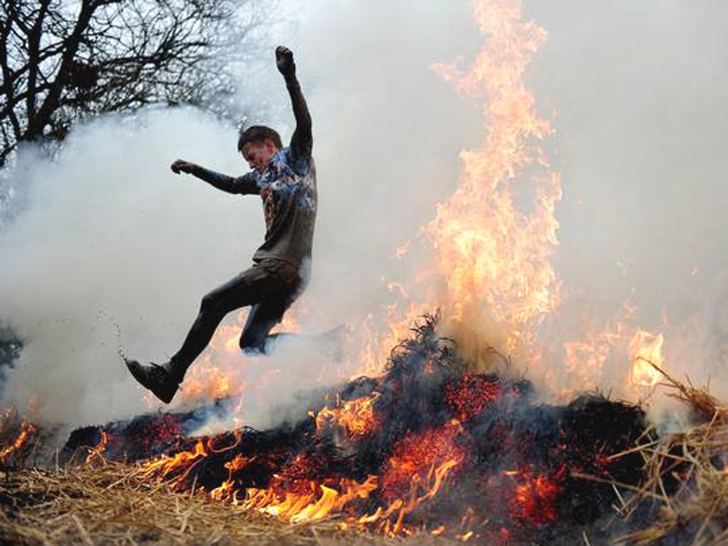 A contender in this year's Tough Guy Challenge suffers the fire, mud, wet and cold in Telford, Shropshire.