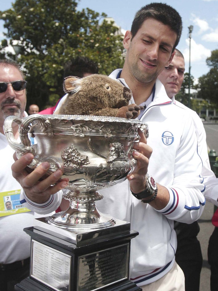 Novak Djokovic enjoys his prizes after winning the
Australian Open