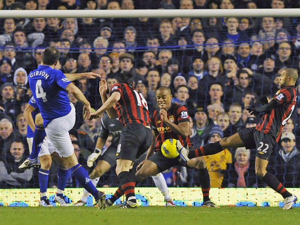 Manchester City players try to block Gibson's match-winner