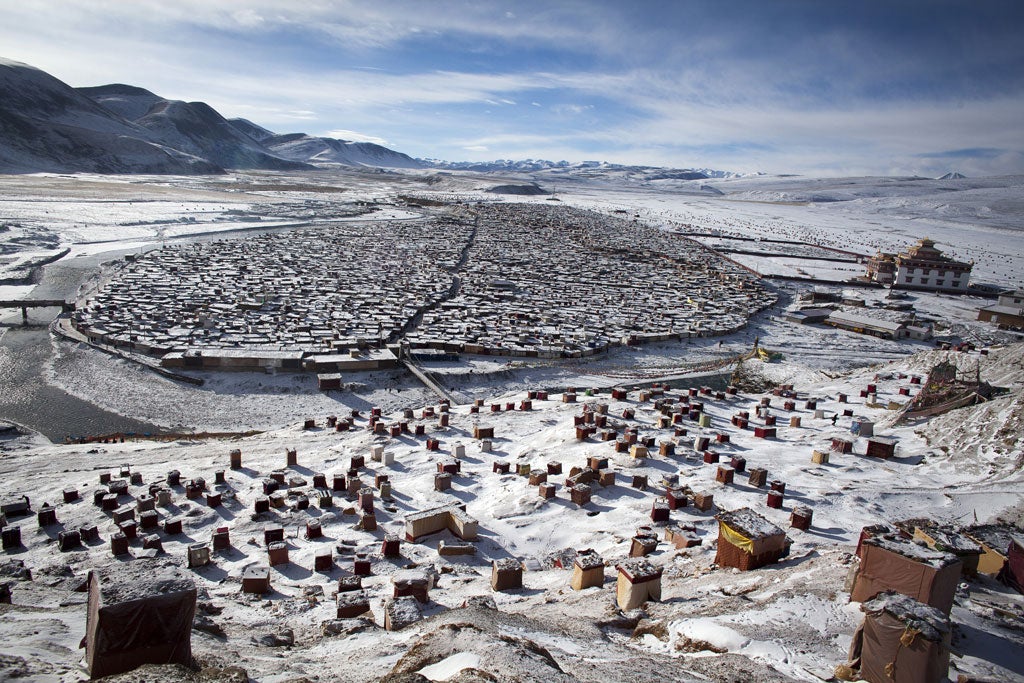 Free of the world: Nuns from the Yarchen encampment take to the thousands of one-person huts near the Nyingma Buddhist monastery to spend the day praying, meditating and singing