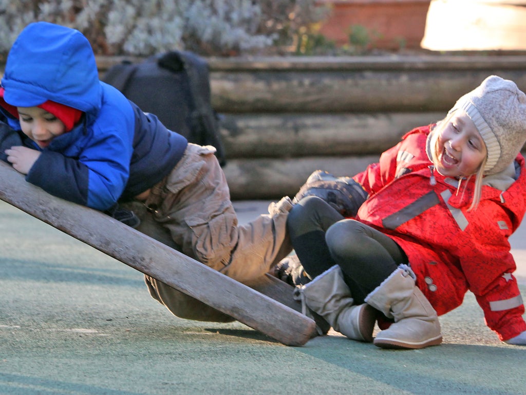 Children aged three and four are pictured playing with each other in the playground of the Thomas Coram Centre for Children and Families