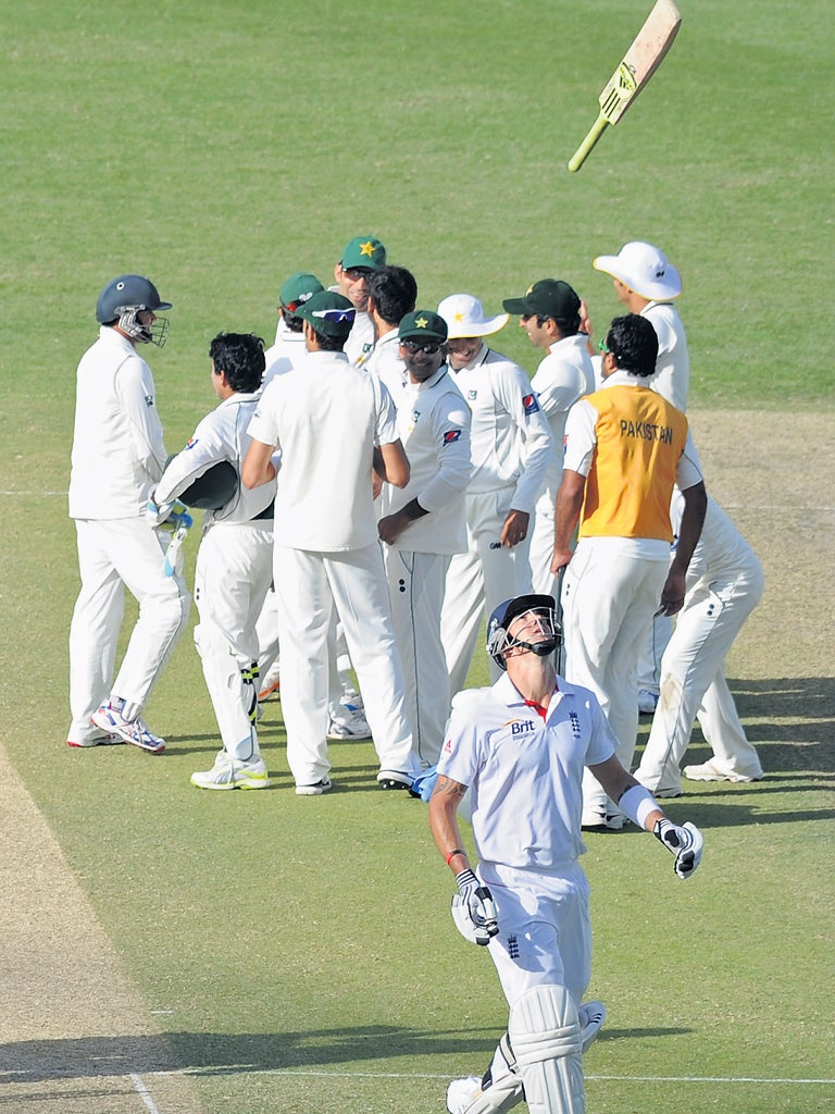 A frustrated Kevin Pietersen throws his bat in the air after being given out lbw to Abdur Rehman on review