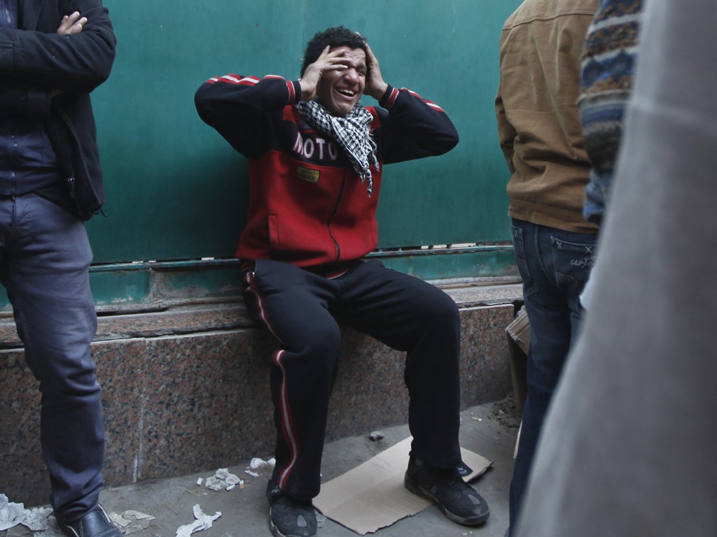 Devastated families wait outside a Cairo morgue to claim the bodies of relatives who were among 74 killed during the violence in a Port Said football stadium last week