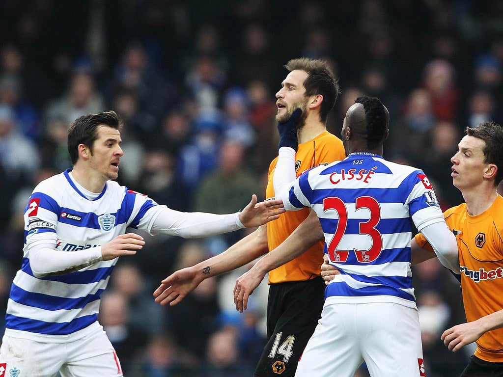 Turning point: QPR’s Djibril Cissé grabs Roger Johnson of Wolves and is sent off