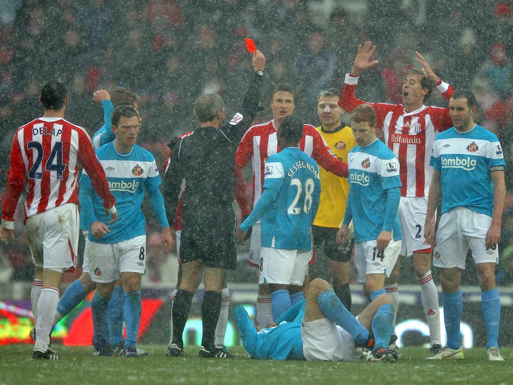 Red rag: Robert Huth is sent off after his challenge on David Meyler had the Sunderland player rolling on the floor