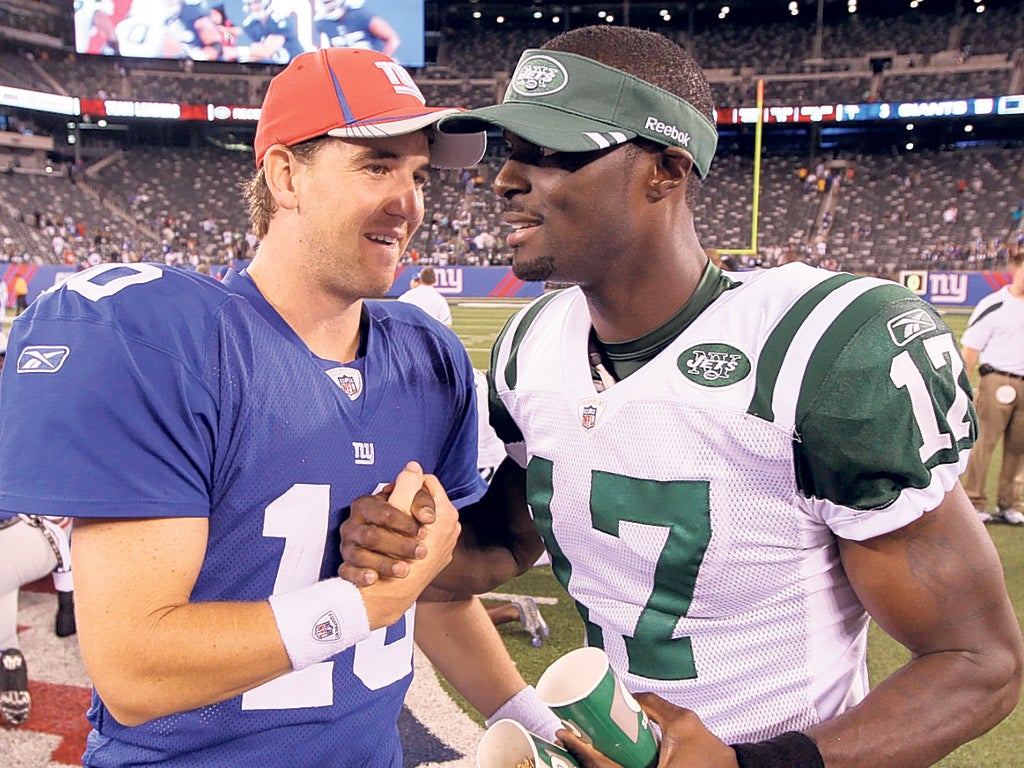 Throwback: Eli Manning (left) is reunited with Plaxico Burress, who now plays for the Giants’ New York rivals the Jets