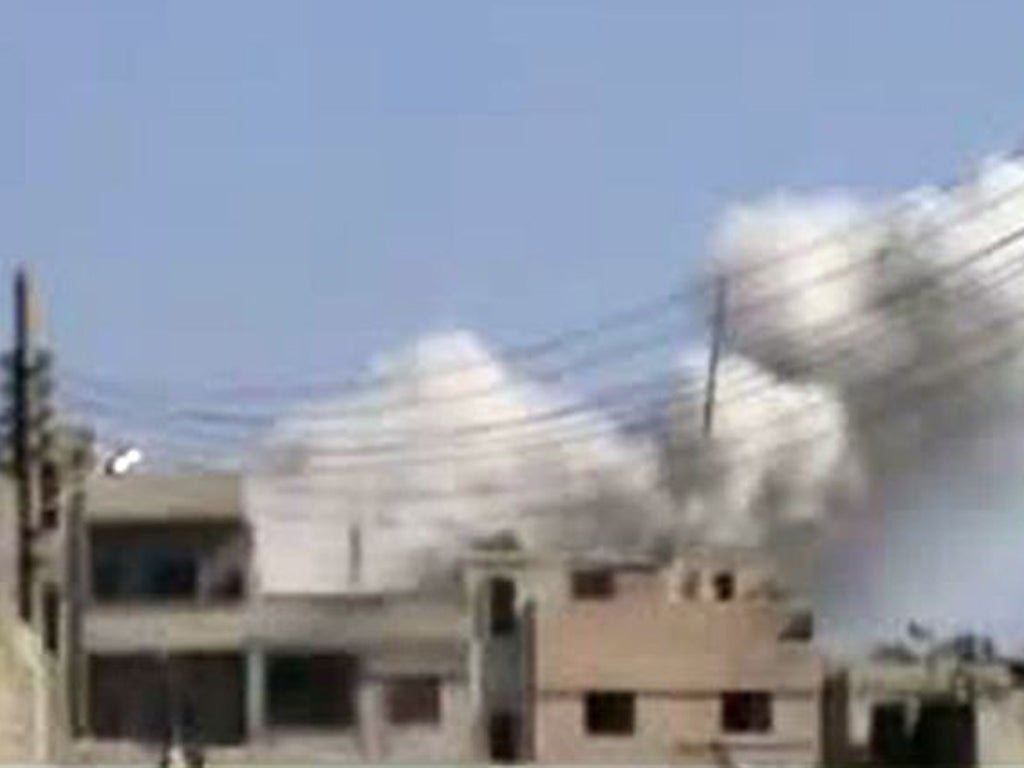 An image grab taken from a video uploaded on YouTube on February 5, 2012 shows smoke billowing from the Baba Amr neighbourhood after shells were fired in the flashpoint Syrian city of Homs