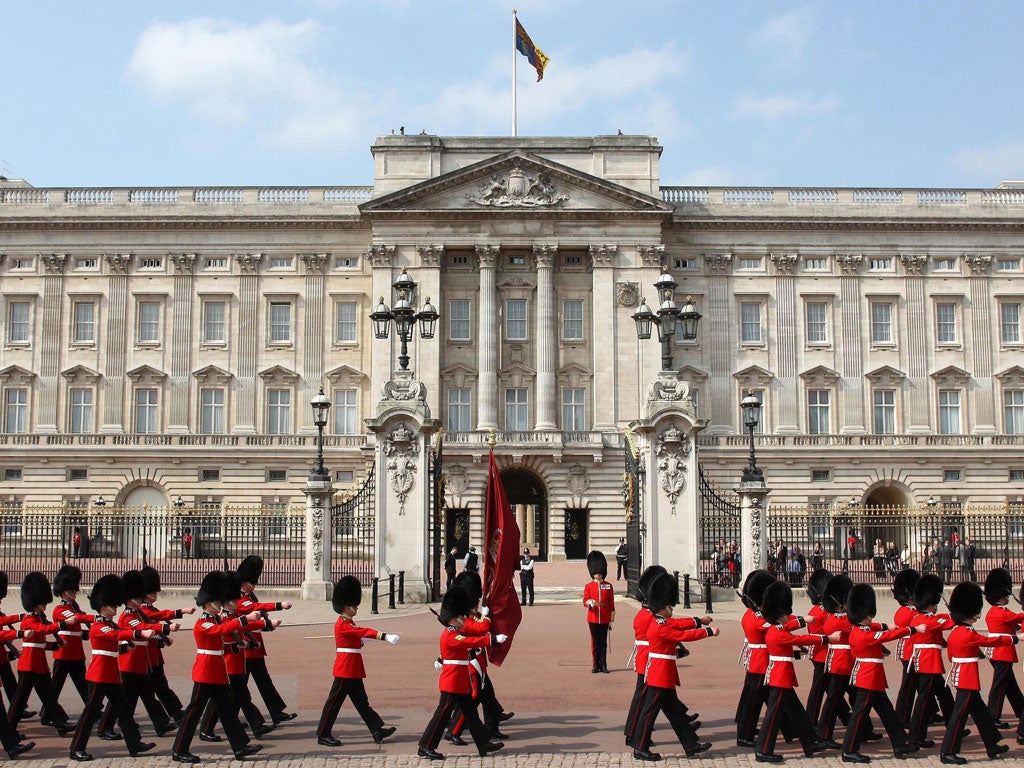 A royal footman who poured whisky into the corgis' water as a party trick was rewarded with a salary cut and a demotion.