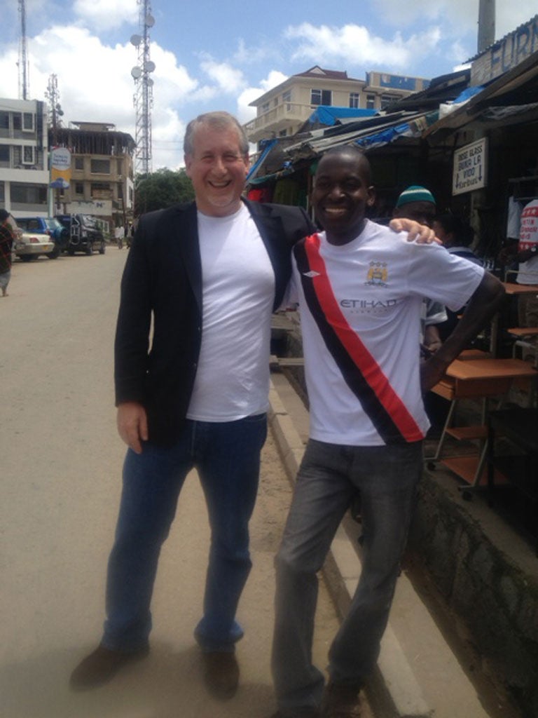 Simon meets Julius, bedecked in his Manchester City shirt, in a Tanzanian market.