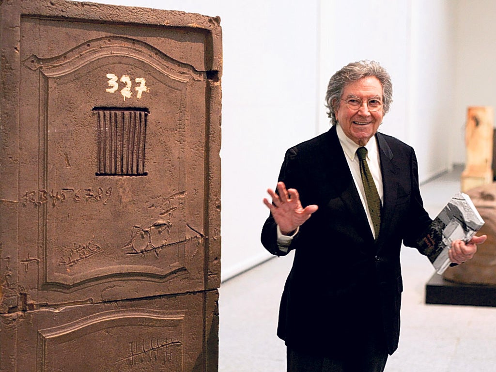 Tapies next to one of his pieces during an exhibition of his work in Madrid in 2004