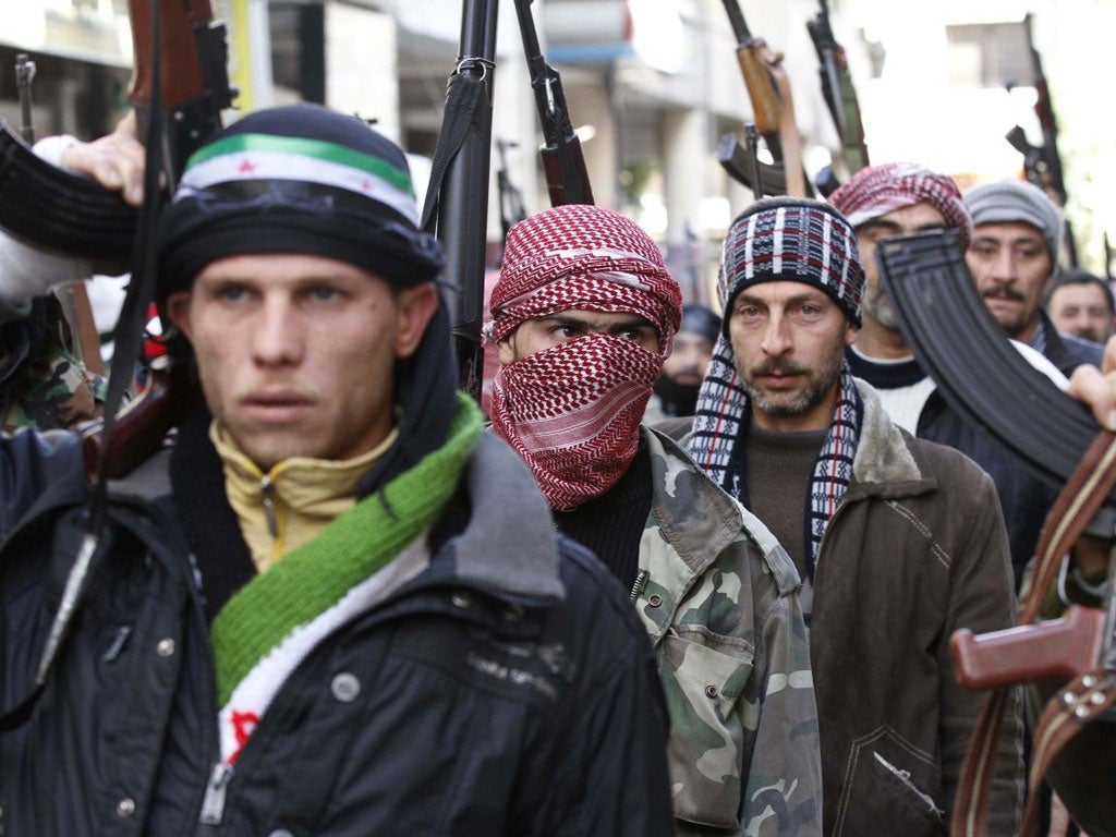 Faces of defiance: a show of strength from Syrian rebels in Idlib, on a day of widespread demonstrations and continued killings