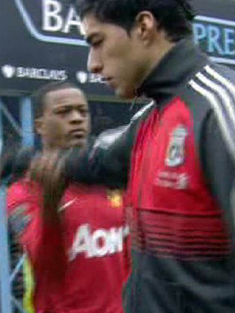 Luis Suarez fails to shake hands with Patrice Evra