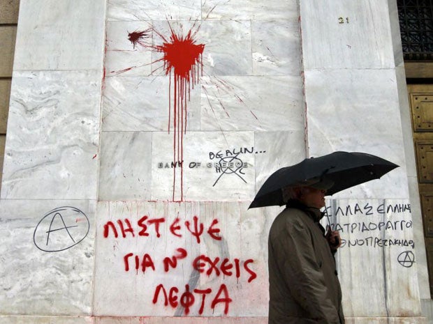 The defaced facade of the Bank of Greece after a night of violence