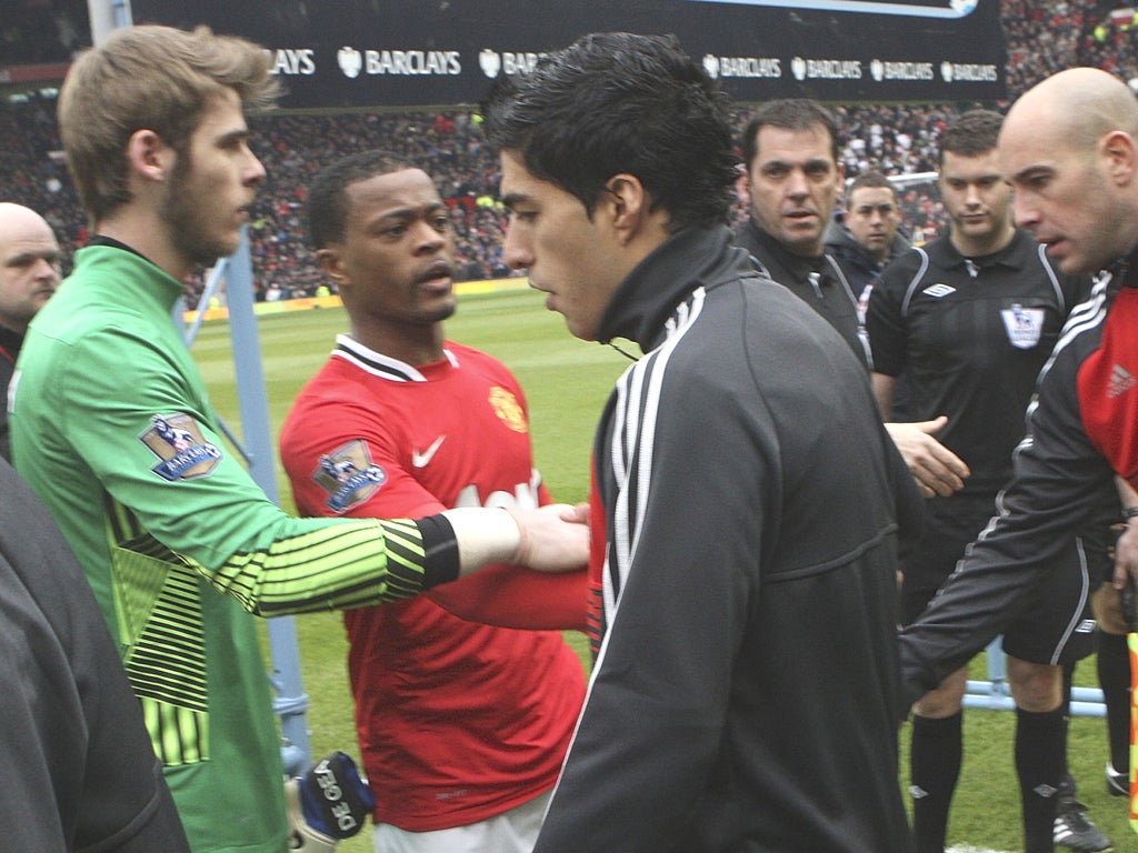 Liverpool’s Luis Suarez refuses to shake Patrice Evra’s hand