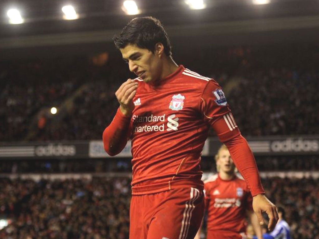 Luis Suarez (No 7) thanks Andy Carroll (No 9) for setting up his goal after the Uruguayan striker had earlier missed a penalty